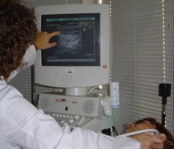 Photo, of Lisa Orloff performing an ultrasound exame, by Stuart Kraybill